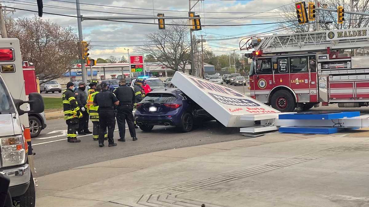 Strong winds send gas station sign crashing onto car in Malden