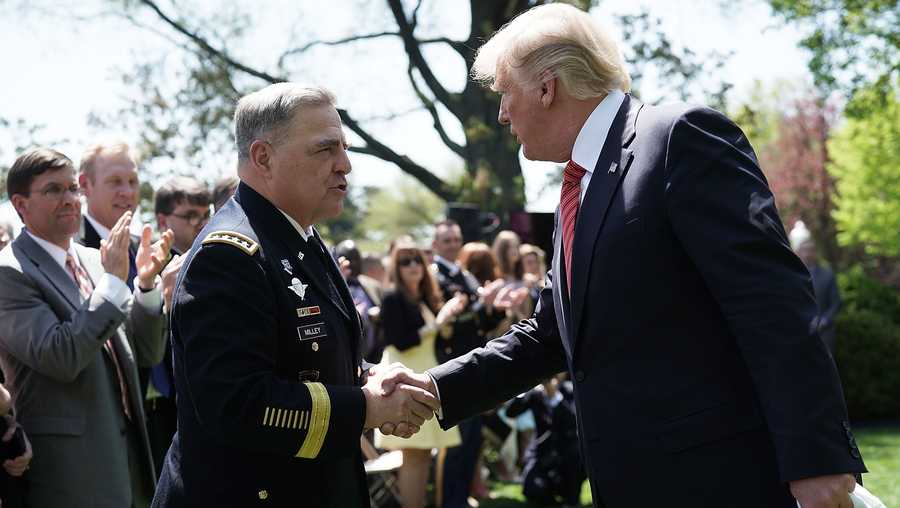 President Donald Trump shakes hands with U.S. Army Chief of Staff Mark Milley during a Rose Garden event with the Army Black Knights football team of the U.S. Military Academy May 1, 2018 at the White House in Washington, D.C.