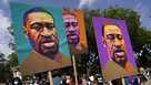 In this Aug. 28, 2020, file photo, people carry posters with George Floyd on them as they march from the Lincoln Memorial to the Martin Luther King Jr. Memorial in Washington.