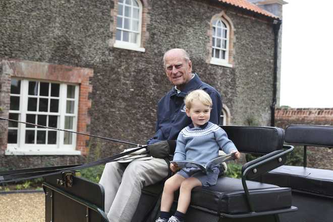 In&#x20;this&#x20;undated&#x20;handout&#x20;photo&#x20;provided&#x20;by&#x20;the&#x20;Duke&#x20;and&#x20;Duchess&#x20;of&#x20;Cambridge,&#x20;Britain&#x27;s&#x20;Prince&#x20;Philip&#x20;sits&#x20;with&#x20;his&#x20;great-grandson&#x20;Prince&#x20;George&#x20;in&#x20;England.