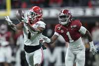 Georgia's George Pickens catches a pass in front of Alabama's Kool-Aid McKinstry during the first half of the College Football Playoff championship football game Monday, Jan. 10, 2022, in Indianapolis.