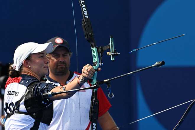 US' Casey Kaufhold (L) and Brady Ellison compete during the archery mixed team elimination round during the Paris 2024 Olympic Games at the Esplanade des Invalides in Paris on August 2, 2024. (Photo by Punit PARANJPE / AFP) (Photo by PUNIT PARANJPE/AFP via Getty Images)