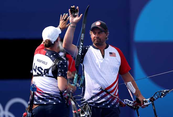 PARIS, FRANCE - AUGUST 02: Brady Ellison of Team United States interacts with Casey Kaufhold of Team United States during the Mixed Team 1/8 Elimination Round match between Team United States and Team Uzbekistan on day seven of the Olympic Games Paris 2024 at Esplanade Des Invalides on August 02, 2024 in Paris, France. (Photo by Alex Pantling/Getty Images)