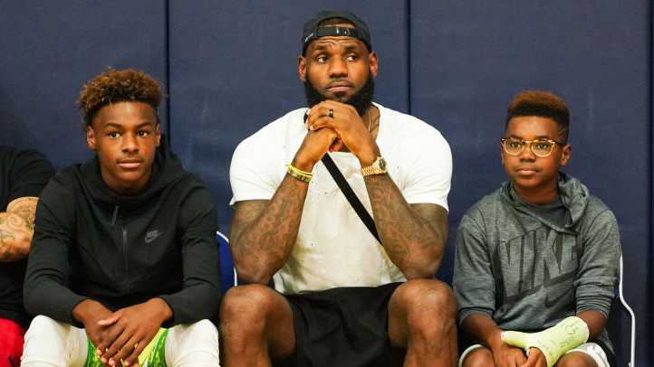 LeBron James Jr., LeBron James Sr. and Bryce Maximus James watch Zaire Wade’s AAU game court side at the Fab 48 tournament at Bishop Gorman High School on July 26, 2018, in Las Vegas, Nevada.