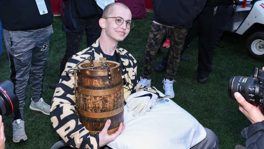 Purdue honorary captain Tyler Trent with the Old Oaken Bucket following a college football game between the Purdue Boilermakers and Indiana Hoosiers on November 24, 2018, at Memorial Stadium in Bloomington, Ind.