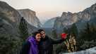 Traveler women taking selfie with the Yosemite Tunnel View on sunset.
