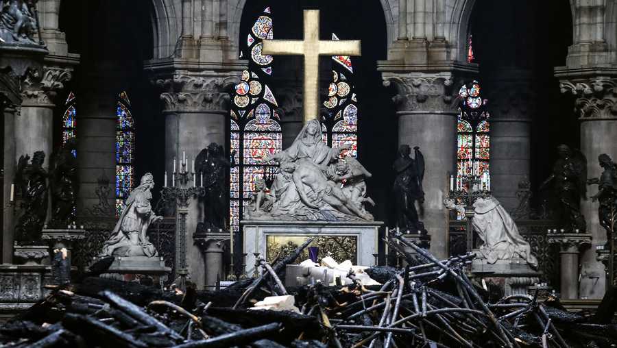 A picture taken on April 16, 2019 shows the altar surrounded by charred debris inside the Notre-Dame Cathedral in Paris in the aftermath of a fire that devastated the cathedral. 
