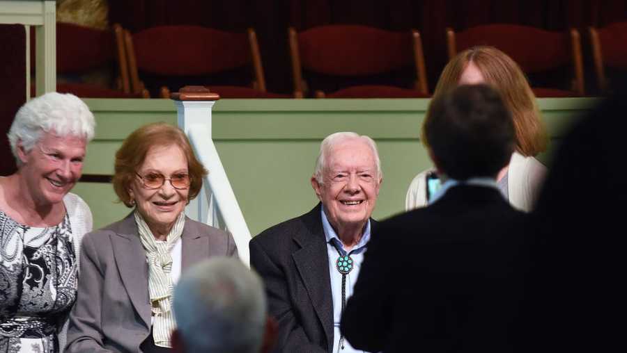Former U.S. President Jimmy Carter and his wife, Rosalynn Carter, pose for a photograph with church attendees at Maranatha Baptist Church after Carter taught Sunday school in his hometown of Plains, Georgia on April 28, 2019. Carter, 94, has taught Sunday school at the church on a regular basis since leaving the White House in 1981, drawing hundreds of visitors who arrive hours before the 10:00 am lesson in order to get a seat and have a photograph taken with the former President and former First Lady Rosalynn Carter.