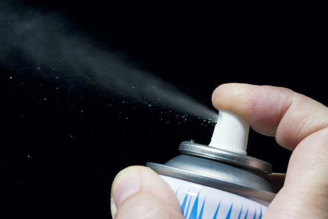 can of snow spray being used
