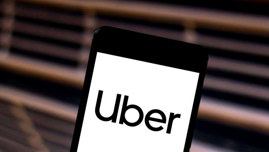 In this photo illustration the Uber logo is seen displayed on a smartphone.