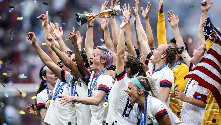 LYON, FRANCE - JULY 07: (EDITORS NOTE: Image has been digitally enhanced.) Megan Rapinoe of the USA lifts the FIFA Women&apos;s World Cup Trophy following her team&apos;s victory in the 2019 FIFA Women&apos;s World Cup France Final match between The United States of America and The Netherlands at Stade de Lyon on July 07, 2019 in Lyon, France. (Photo by Alex Grimm/Getty Images)