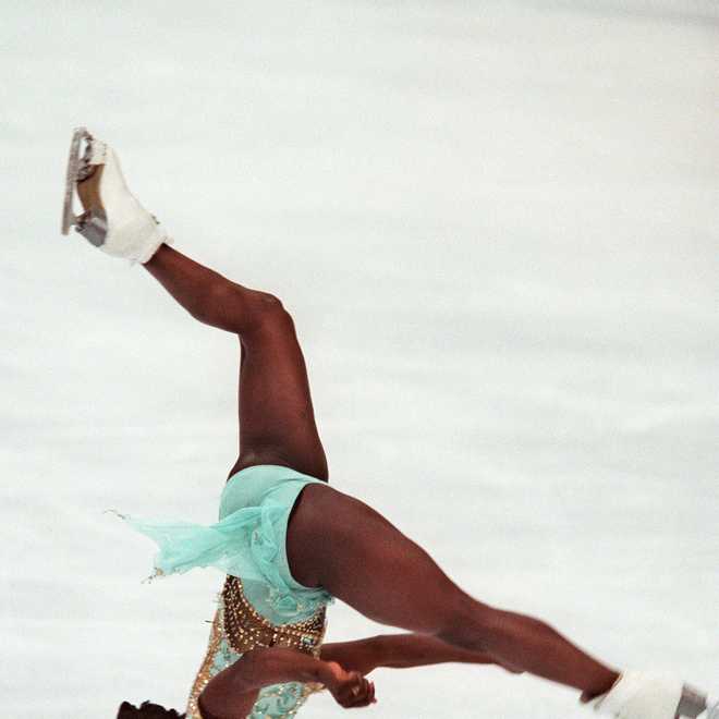 Surya Bonaly of France performs a backflip in her free skate routine in the women's Olympic figure skating in Nagano on February. 20, 1998. The flip is not permitted in skating competition, but Bonaly said afterwards that she knew she could not win a medal so did it for the spectators.