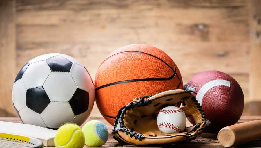 High Angle View Of Various Sport Accessories On Textured Wooden Surface