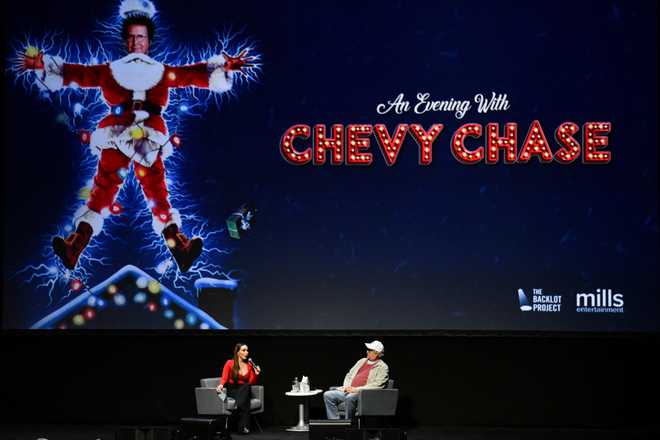 LOS ANGELES, CALIFORNIA - DECEMBER 05: Chevy Chase speaks with moderator Yenitza Munoz during a Q&amp;A session following a special screening of &quot;National Lampoon&apos;s Christmas Vacation&quot; at Microsoft Theater on December 05, 2019 in Los Angeles, California. (Photo by Allen Berezovsky/Getty Images)