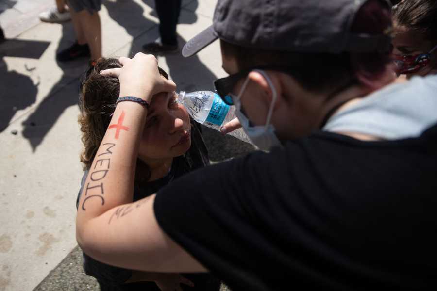 A protester receives first aid Saturday in Columbus, Ohio after being sprayed with pepper spray by police outside the state house during a rally over the death of George Floyd. A protester receives first aid Saturday in Columbus, Ohio after being sprayed with pepper spray by police outside the state house during a rally over the death of George Floyd.