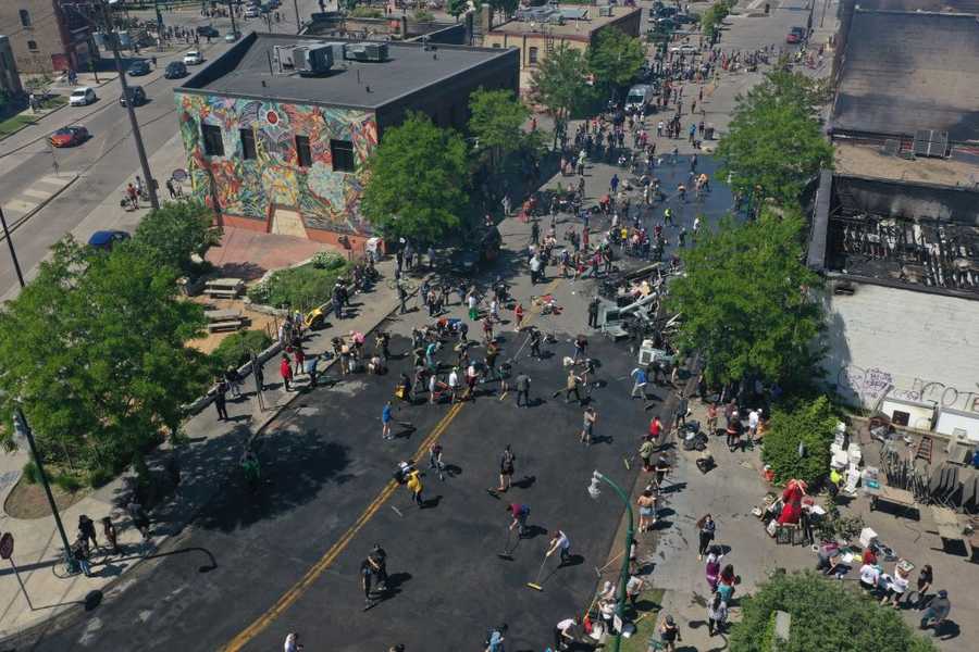An aerial view of volunteers cleaning trash and debris Saturday in Minneapolis after riots over the death of an unarmed black man George Floyd, who was killed as he was pinned down by a white police officer. An aerial view of volunteers cleaning trash and debris Saturday in Minneapolis after riots over the death of an unarmed black man George Floyd, who was killed as he was pinned down by a white police officer.