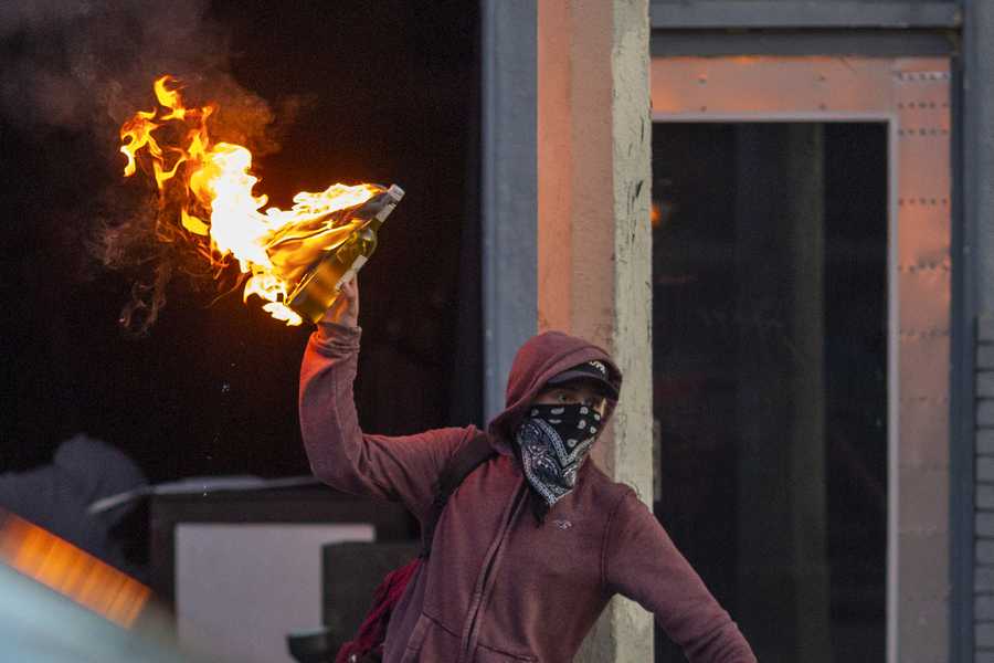 Black Lives Matter Holds Protest In Los Angeles After Death Of George Floyd A man throws a Molotov cocktail on Melrose Avenue in the Fairfax District during demonstrations following the death of George Floyd on May 30, 2020 in Los Angeles, California.