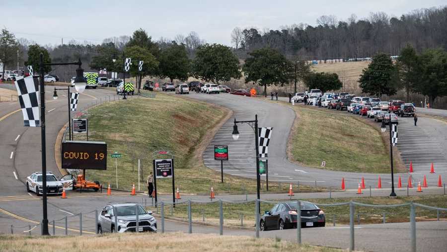 People arrive at a COVID-19 mass vaccination site at Martinsville speedway in Ridgeway, Virginia on March 12, 2021.