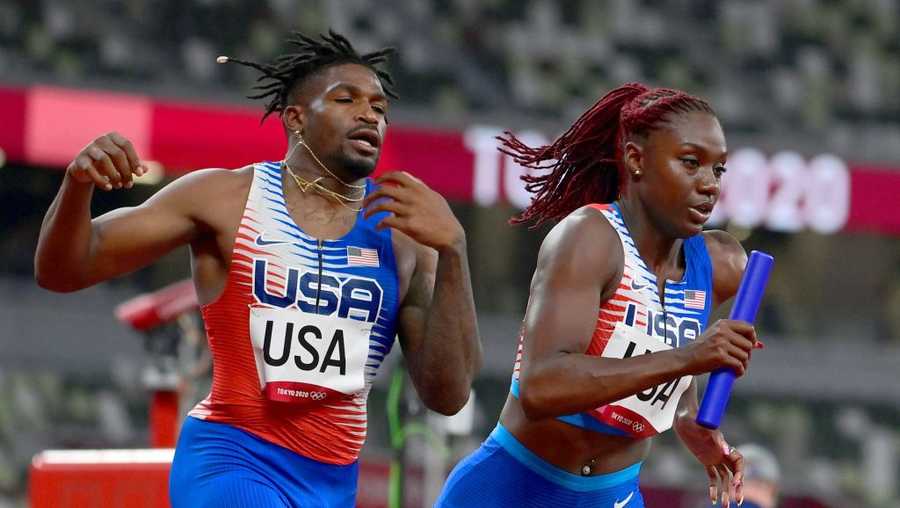 USA&apos;s Elija Godwin (L) and Lynna Irby compete in the mixed 4x400m relay heats during the Tokyo 2020 Olympic Games at the Olympic Stadium in Tokyo on July 30, 2021. (Photo by Javier SORIANO / AFP) (Photo by JAVIER SORIANO/AFP via Getty Images)