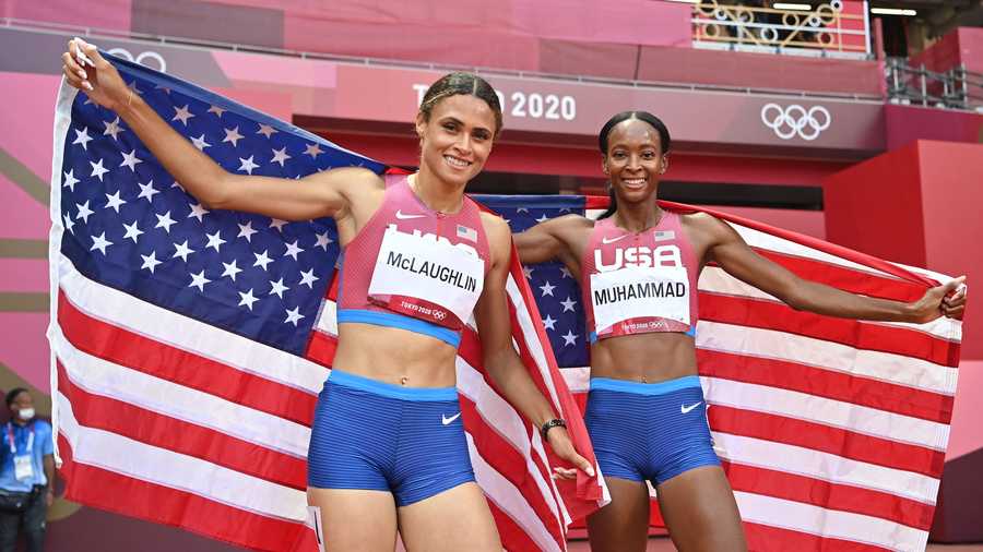 First-placed USA's Sydney Mclaughlin (L) and second-placed USA's Dalilah Muhammad celebrate after competing in the women&apos;s 400m hurdles final during the Tokyo 2020 Olympic Games at the Olympic Stadium in Tokyo on August 4, 2021. (Photo by Andrej ISAKOVIC / POOL / AFP) (Photo by ANDREJ ISAKOVIC/POOL/AFP via Getty Images)