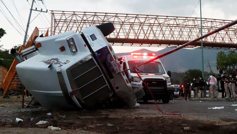 A truck that was transporting migrants is seen rolled over after a traffic accident that killed migrants from Central America on Dec. 9, 2021 in Tuxtla Gutierrez, Mexico.