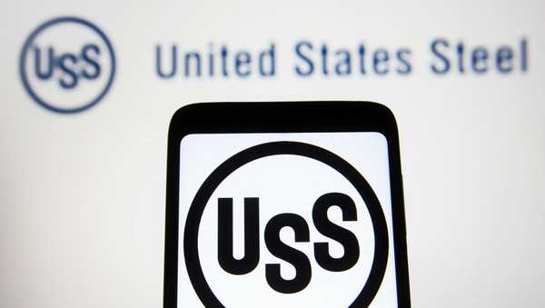 In this photo illustration, U.S. Steel (United States Steel Corporation)(USS) logo is seen on a smartphone and a computer screen.