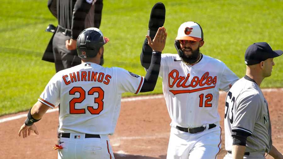 BALTIMORE, MD - APRIL 17: Baltimore Orioles catcher Robinson Chirinos (23) and second baseman Rougned Odor (12) score in the eighth inning during a MLB game between the New York Yankees and the Baltimore Orioles on April 17, 2022, at Oriole Park at Camden Yards, in Baltimore, Maryland. 
(Photo by Tony Quinn/Icon Sportswire via Getty Images)