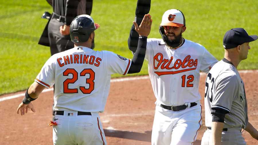 BALTIMORE, MD - APRIL 17: Baltimore Orioles catcher Robinson Chirinos (23) and second baseman Rougned Odor (12) score in the eighth inning during a MLB game between the New York Yankees and the Baltimore Orioles on April 17, 2022, at Oriole Park at Camden Yards, in Baltimore, Maryland. 
(Photo by Tony Quinn/Icon Sportswire via Getty Images)