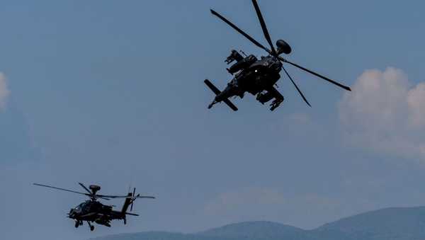 US AH-64 Apache helicopters fly during the Swift Response 22 military exercise at the Krivolak Military Training Center in Negotino, in the centre of North Macedonia, on May 12, 2022. - The excercise, which involves approximately 4,600 soldiers from North Macedonia, Albania, Montenegro, Greece, Italy, as well as France, the UK and the US, is meant to show that NATO forces can be deployed around the world and fully cooperate. (Photo by Robert ATANASOVSKI / AFP) (Photo by ROBERT ATANASOVSKI/AFP via Getty Images)