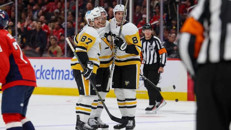 WASHINGTON, DC - NOVEMBER 9: Sam Poulin #22 of the Pittsburgh Penguins celebrates a goal against the Washington Capitals with Sidney Crosby #87 and Brian Dumoulin #8 at Capital One Arena on November 9, 2022 in Washington, D.C. (Photo by John McCreary/NHLI via Getty Images)