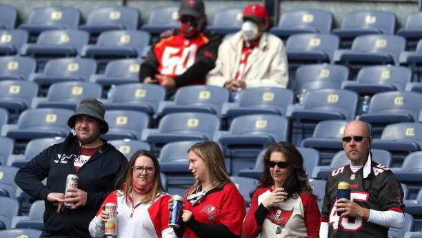 DENVER, COLORADO - SEPTEMBER 27: Tampa Bay Buccaneers fans drink beer as they look on before the Buccaneers play against the Denver Broncos at Empower Field At Mile High on September 27, 2020 in Denver, Colorado. (Photo by Matthew Stockman/Getty Images)