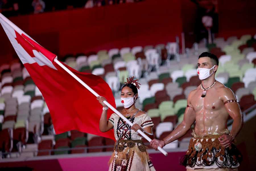 Flag bearers Malia Paseka and Pita Taufatofua of Team Tonga lead their team during the Opening Ceremony of the Tokyo 2020 Olympic Games at Olympic Stadium on July 23, 2021 in Tokyo, Japan.