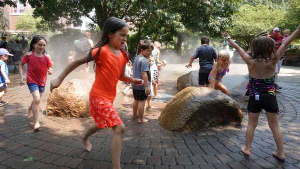 DES MOINES, IOWA - AUGUST 19: Children use a misting fountain to escape mid-day heat at the Iowa State Fair on August 19, 2021 in Des Moines, Iowa. The fair, which runs from August 12-22, typically draws between 80-100,000 people each day. The fair was cancelled in 2020 due to the COVID-19 pandemic.  (Photo by Scott Olson/Getty Images)