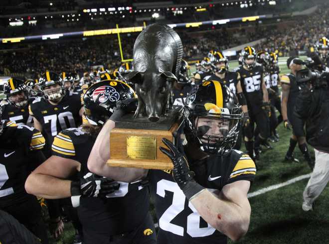 IOWA&#x20;CITY,&#x20;IOWA-&#x20;NOVEMBER&#x20;13&#x3A;&#x20;&#x20;Defensive&#x20;back&#x20;Jack&#x20;Koerner&#x20;&#x23;28&#x20;of&#x20;the&#x20;Iowa&#x20;Hawkeyes&#x20;holds&#x20;the&#x20;Floyd&#x20;of&#x20;Rosedale&#x20;trophy&#x20;after&#x20;their&#x20;match-up&#x20;against&#x20;the&#x20;Minnesota&#x20;Golden&#x20;Gophers&#x20;at&#x20;Kinnick&#x20;Stadium&#x20;on&#x20;November&#x20;13,&#x20;2021&#x20;in&#x20;Iowa&#x20;City,&#x20;Iowa.&#x20;&#x20;&#x28;Photo&#x20;by&#x20;Matthew&#x20;Holst&#x2F;Getty&#x20;Images&#x29;