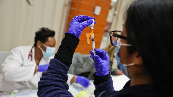 Freeport, N.Y.: Dr. Twana Jackson prepares pediatric doses of the Pfizer COVID-19 vaccine as the Mount Sinai South Nassau Vaxmobile vists Freeport High School in Freeport, New York on November 30, 2021. (Photo by Steve Pfost/Newsday RM via Getty Images)