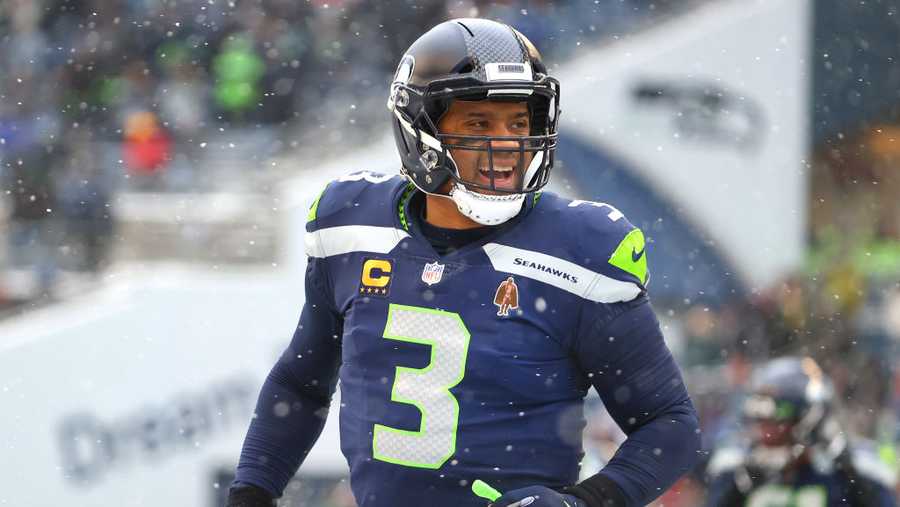 Russell Wilson #3 of the Seattle Seahawks reacts after Rashaad Penny #20 scores a touchdown during the second quarter against the Chicago Bears at Lumen Field on December 26, 2021 in Seattle, Washington.