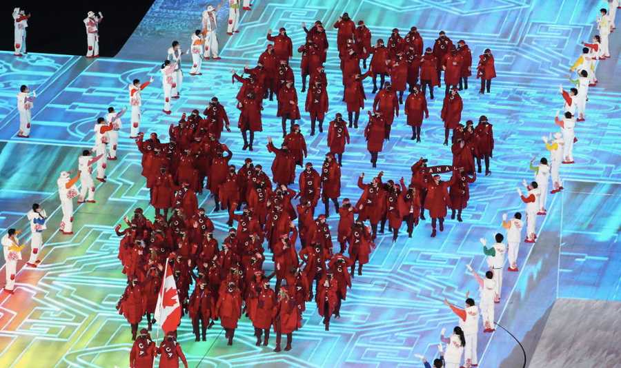 Opening Ceremony - Beijing 2022 Winter Olympics Day 0 BEIJING, CHINA - FEBRUARY 04: Flag bearers Charles Hamelin and Marie-Philip Poulin of Team Canada lead their team out during the Opening Ceremony of the Beijing 2022 Winter Olympics at the Beijing National Stadium on February 04, 2022 in Beijing, China. (Photo by Xavier Laine/Getty Images)