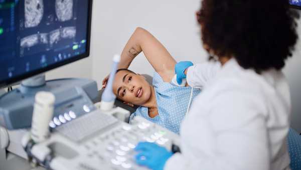 A young woman is doing a breast ultrasound for preventive breast cancer care