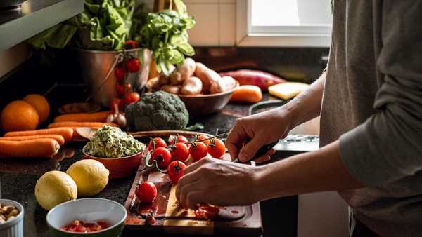 shot of a vegan meal preparation with lots of vegetables and fruits on a domestic kitchen