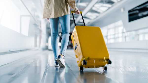 International airport terminal. Asian beautiful woman with luggage and walking in airport