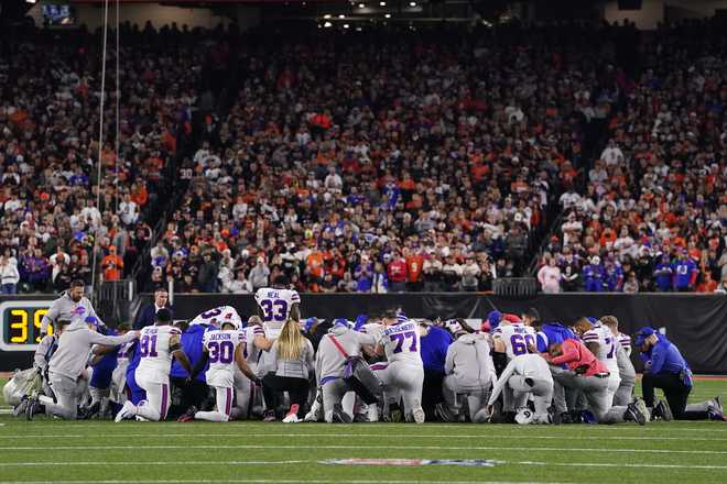 CINCINNATI, OHIO - JANUARY 02: Buffalo Bills players huddle together and pray;  after teammate Damar Hamlin #3 collapsed on the field after making a tackle against the Cincinnati Bengals during the first quarter at Paycor Stadium;on January 02, 2023 at&#x20 ;Cincinnati, Ohio. (Photo by Dylan Buell/Getty Images)