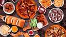 Super Bowl or football theme food table scene, overhead view on dark wood