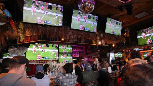 NEWPORT BEACH, CALIFORNIA - FEBRUARY 12: People watch Super Bowl LVII between the Philadelphia Eagles and the Kansas City Chiefs on televisions at a bar on February 12, 2023 in Newport Beach, California. (Photo by I RYU/VCG via Getty Images)