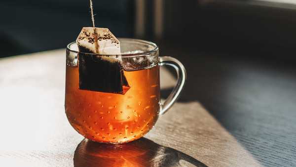 Tea bag put in transparent glass teacup