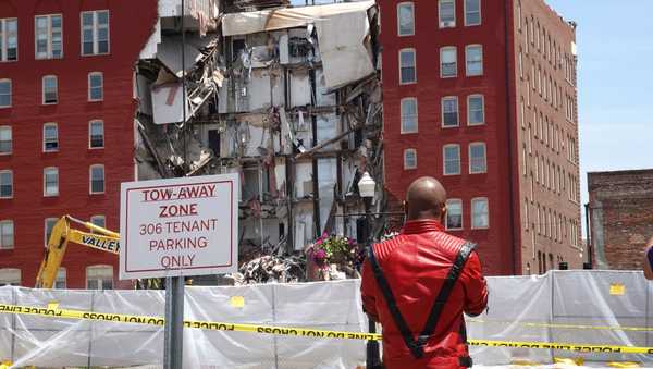 DAVENPORT, IOWA - MAY 29: People view a six-story apartment building after it collapsed yesterday on May 29, 2023 in Davenport, Iowa. Eight people were rescued from the debris following the collapse yesterday afternoon.  (Photo by Scott Olson/Getty Images)