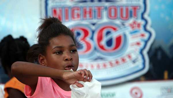 Tamyra Hall, 8, eats popcorn during the National Night Out gathering at the Millstone Apartment Complex on Tuesday, Oct. 1, 2013, in Katy. ( Mayra Beltran / Houston Chronicle ) (Photo by Mayra Beltran/Houston Chronicle via Getty Images)