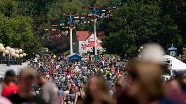 Attendees walk through the Iowa State Fair in Des Moines, Iowa, on August 15, 2023. (Photo by Stefani Reynolds / AFP) (Photo by STEFANI REYNOLDS/AFP via Getty Images)