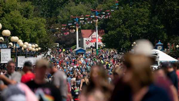 Attendees walk through the Iowa State Fair in Des Moines, Iowa, on August 15, 2023. (Photo by Stefani Reynolds / AFP) (Photo by STEFANI REYNOLDS/AFP via Getty Images)