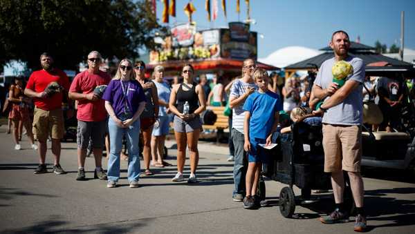 DES MOINES, IOWA - AUGUST 11: Fairgoers pause with their hands over their hearts to listen to the playing of the national anthem at the Iowa State Fair on August 11, 2023 in Des Moines, Iowa. Republican and Democratic presidential hopefuls, including Florida Governor Ron DeSantis and former President Donald Trump, are expected to visit the fair, a tradition in one of the first states to hold caucuses in 2024. (Photo by Chip Somodevilla/Getty Images)