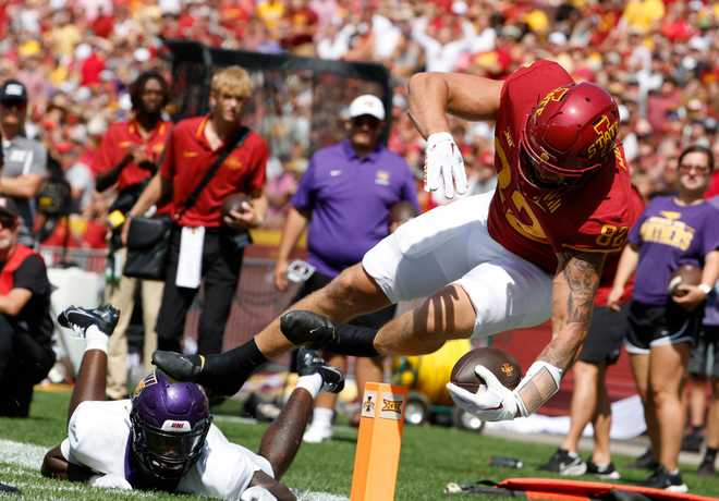 AMES,&#x20;IA&#x20;-&#x20;SEPTEMBER&#x20;2&#x3A;&#x20;Tight&#x20;end&#x20;Tyler&#x20;Moore&#x20;&#x23;82&#x20;of&#x20;the&#x20;Iowa&#x20;State&#x20;Cyclones&#x20;dives&#x20;into&#x20;the&#x20;end&#x20;zone&#x20;for&#x20;a&#x20;touchdown&#x20;as&#x20;defensive&#x20;back&#x20;Brodrick&#x20;Calhoun&#x20;&#x23;14&#x20;of&#x20;Northern&#x20;Iowa&#x20;defends&#x20;in&#x20;the&#x20;first&#x20;half&#x20;of&#x20;play&#x20;at&#x20;Jack&#x20;Trice&#x20;Stadium&#x20;on&#x20;September&#x20;2,&#x20;2023&#x20;in&#x20;Ames,&#x20;Iowa.&#x20;&#x28;Photo&#x20;by&#x20;David&#x20;Purdy&#x2F;Getty&#x20;Images&#x29;